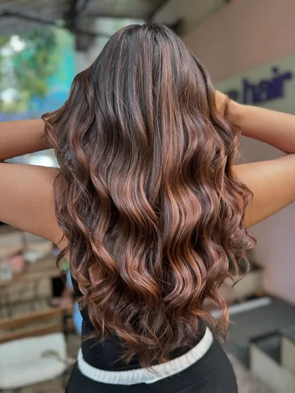 The back view of this stunning bridal hair. The waves are perfectly styled to show off the multi-tonal brunette color.