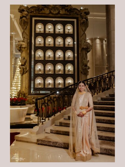 A grand bridal portrait on a majestic staircase, showcasing her elegance.