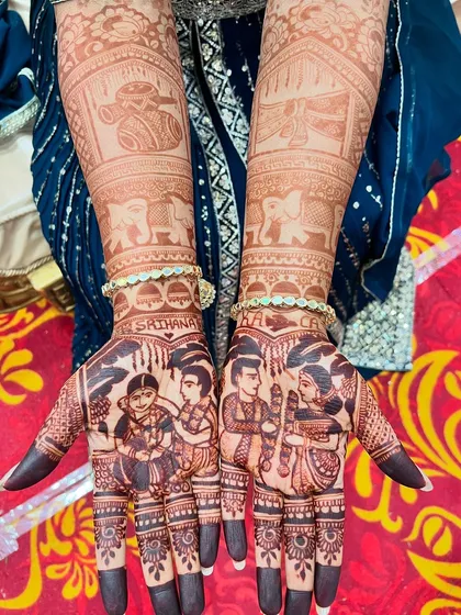 A beautiful bridal portrait mehendi, showcasing the rich, dark stain of my organic henna. The design includes the bride and groom, their family, and traditional wedding symbols.