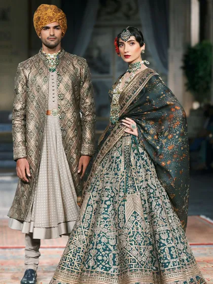 A royal-looking couple on the runway for designer JJ Valaya. This shot is perfect for bridal and couture lookbooks, showcasing both male and female high fashion.