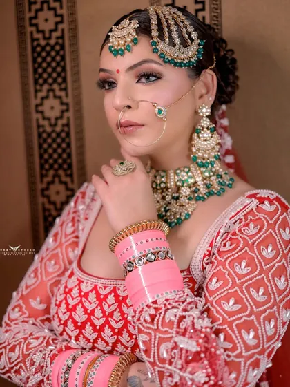 A classic close-up pose, focusing on the intricate details of the bridal jewelry and the texture of the embroidered blouse.