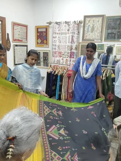 Students from SKV School of Design examining a hand-embroidered Ilkal saree. These visits provide valuable, real-world lessons in craft and design.