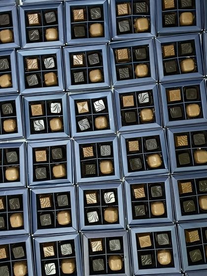 Gifting never tasted so divine. This image shows a large order of our four-piece assorted chocolate boxes, perfect for corporate events or wedding favors.