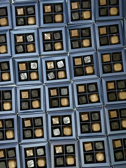 Gifting never tasted so divine. This image shows a large order of our four-piece assorted chocolate boxes, perfect for corporate events or wedding favors.