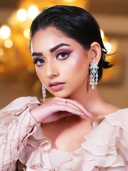 A close-up of the model's face, her gaze intense and her makeup flawless.