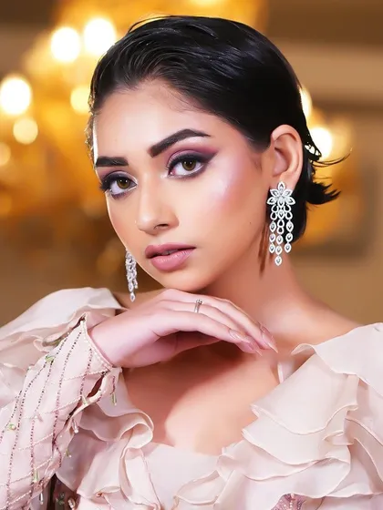 A close-up of the model's face, her gaze intense and her makeup flawless.