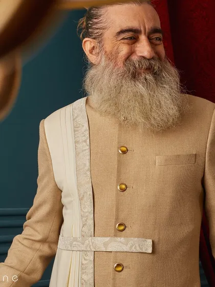A joyful moment captured in our beige draped sherwani. The smile says it all; when you feel good in what you wear, it shows.