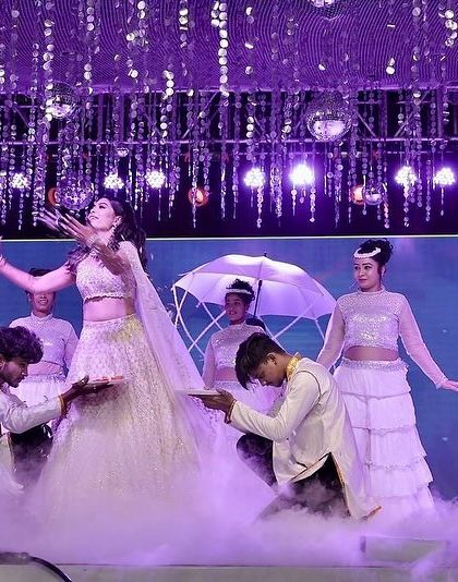 A close up of the bride's performance, surrounded by smoke and backup dancers with fans. These details add so much texture and beauty to a solo act.