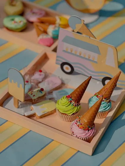 A closer look at the ice cream-themed treats, featuring cupcakes cleverly disguised as ice cream cones with colorful frosting and sprinkles.