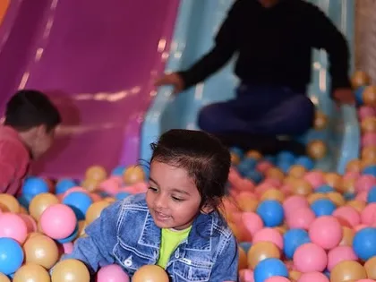 A young guest enjoying the ball pit and slides. Our play area is designed for hours of safe and active fun.