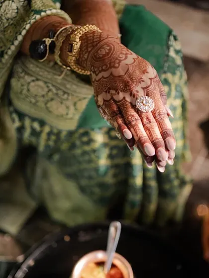 A close-up of the rich henna stain, adorned with beautiful jewellery. The color is just perfect.