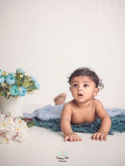 Sometimes the most minimal pictures are the best. This tummy time shot on a clean floor with just a few flowers shows off the baby's natural cuteness.