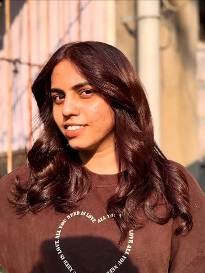 A happy client enjoying her new 'Brownie' hair color. It's a warm and flattering shade.