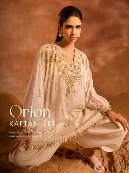 The Orion Kaftan Set, where phoenix-inspired motifs and pearl-infused tassels create an exquisite ensemble. I paired the embellished kaftan with solid dhoti pants for a modern fusion look.