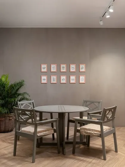 A luxurious cafe concept nestled within a stunning tile showroom. A dramatic rotating door, clad in oversized tiles with mesmerizing digital prints, creates a striking entrance to this innovative and elegant space.