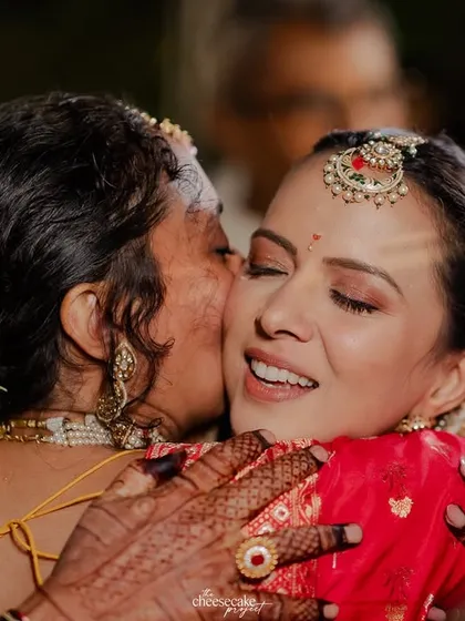 A tight, emotional hug between the bride and her mother during the Vidaai. A moment heavy with love and emotion.