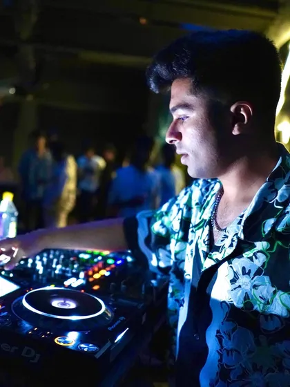 In the zone, focused on the mix. A side profile shot capturing my concentration during a set.