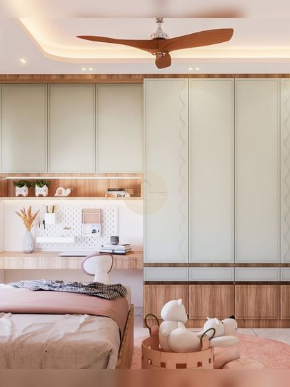 A full view of the kids' room, showing the integrated study desk and floor-to-ceiling wardrobe with mint green shutters. The design maximizes storage while maintaining a light and airy feel.