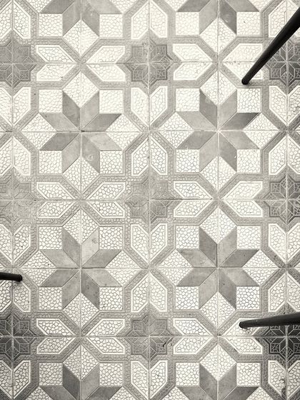 The geometric, star-patterned floor tiles we used in the Jollygunj bar. This top-down shot highlights the graphic quality of the flooring, which adds a layer of visual interest to the space.