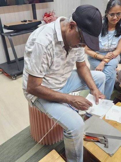 A mentor demonstrates a bookbinding technique at our Sion workshop. These skills are not only practical but also a beautiful way to preserve memories or create gifts.