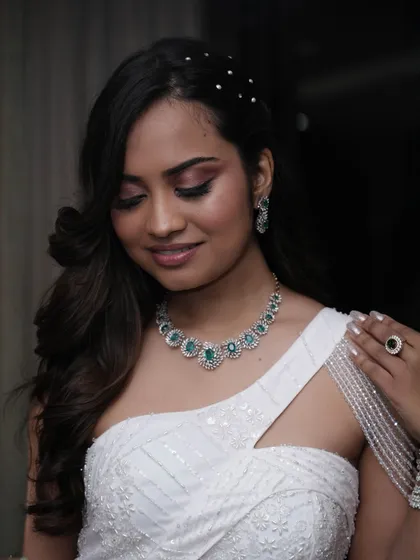 A soft and romantic makeup look for a reception or cocktail party. The eyeshadow has a hint of rosy-brown, and the skin is kept fresh and dewy.