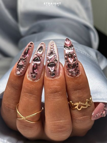 A full view of the sculpted pink chrome heart nails. The dimension and shine on this set are incredible, proving that more is definitely more.