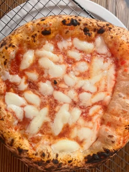 Another perfect Margherita, resting on a cooling rack to keep the bottom crisp. It's all in the details.
