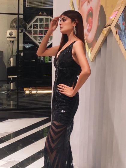 A stylish shot of the actress indoors, showing off the sleek hair and makeup.