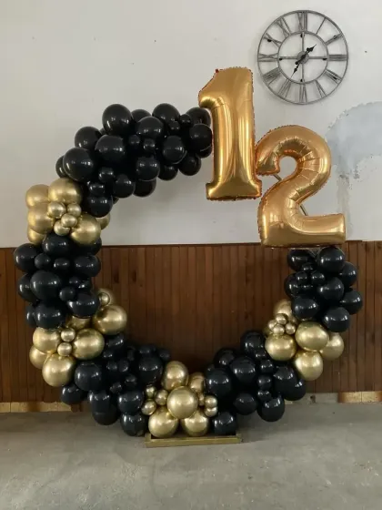 A simple and bold black and gold balloon ring for a 12th birthday.