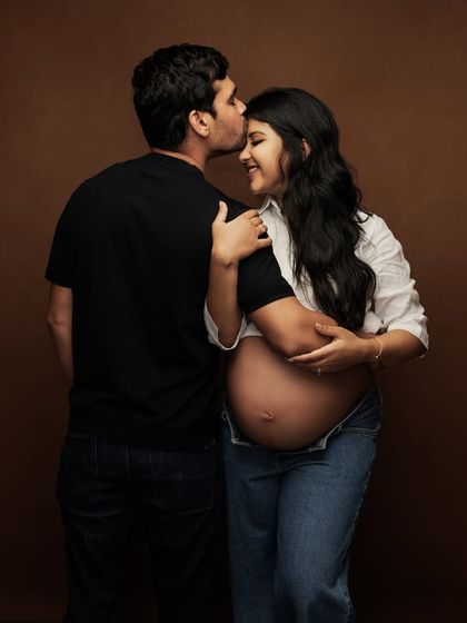 A tender kiss on the forehead. This simple gesture speaks volumes about love and protection.