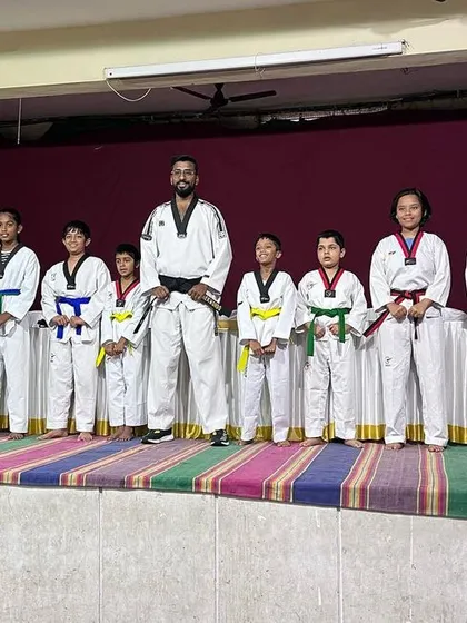 Another group of students lined up on stage after their belt exam. It is rewarding to stand with them and acknowledge their hard work and advancement in the art of Taekwondo.