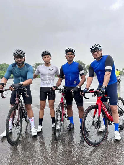 Four members celebrating a birthday, even in the rain.