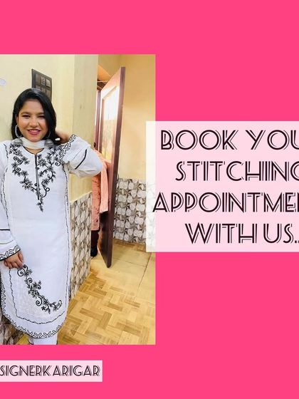 A happy client in her custom white suit with black embroidery. We take pride in our happy customers and their perfectly fitted clothes.