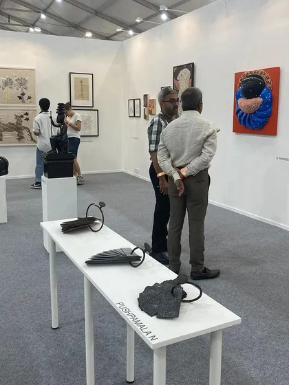 Visitors discussing the works on display.