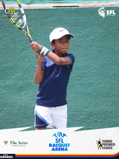 Ready for action. This young player holds his two-handed backhand grip, prepared to return a powerful shot during a competitive match.