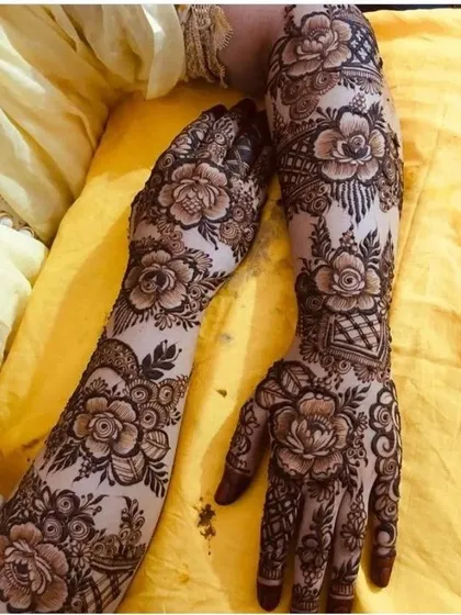 A gorgeous full-arm floral design, with roses and leaves creating a beautiful vine that wraps around the hands.