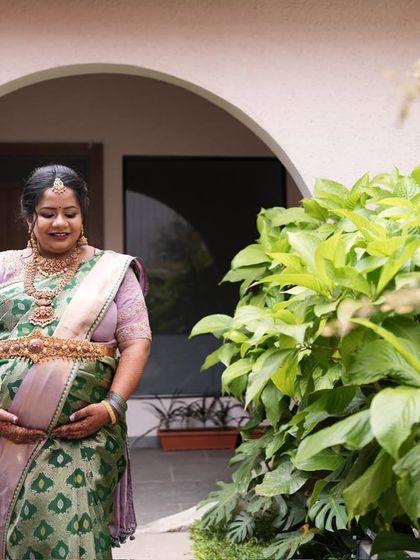 The beautiful drape of the lavender and green saree, a unique combination that celebrates the duality of motherhood.