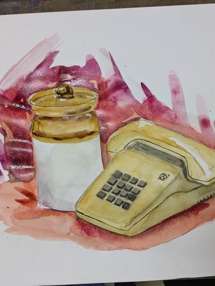 A close-up of a watercolor still life featuring a vintage telephone and a ceramic jar. This piece showcases the use of wet-on-wet techniques to create a soft, atmospheric background.