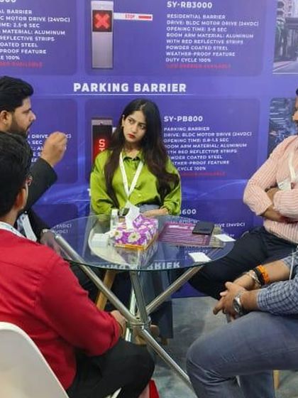 A team meeting with potential clients at Traffic Infratech 2024, discussing the specifications of our residential and parking barrier systems.