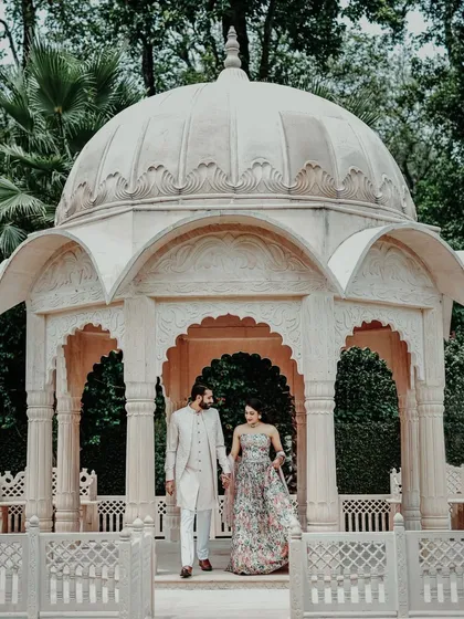 A beautiful couple portrait from a Mehendi ceremony, set against the backdrop of a stunning white marble gazebo.
