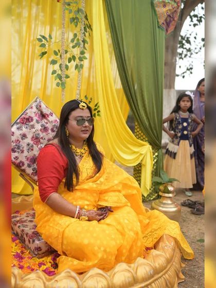 An outdoor Haldi setup showing the arrangement of the urli and the fabric backdrop against a natural setting. We can adapt our decorations for both indoor and outdoor venues.