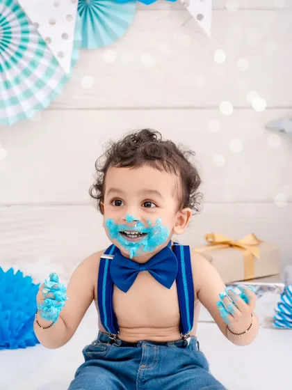 Nothing beats the pure joy of a first birthday cake smash. This little boy, with his bright blue bow tie and even brighter smile, is having the best time making a happy mess. These sessions are all about capturing that uninhibited, playful spirit.