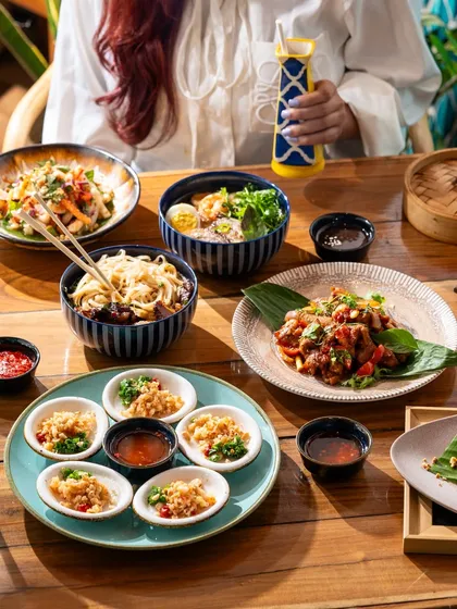 A spread of Vietnamese dishes, including pho and summer rolls. This shot showcases the fresh and vibrant flavors of the cuisine.