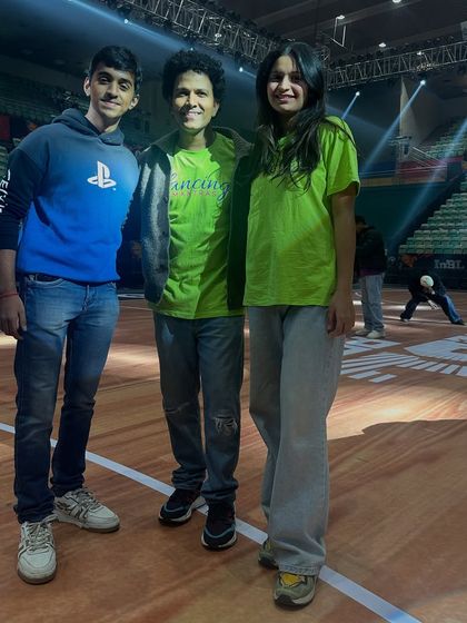 A quick photo with some of my team members during a break in rehearsals at the stadium. The positive energy is constant, even during long practice hours.