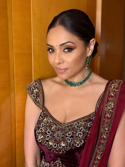A close-up of the bold, smoky eyes. This is a classic evening look that adds a touch of drama and sophistication, perfect for any grand celebration.