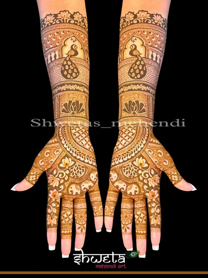 An elegant and symmetrical bridal design. This pattern features peacocks and elephants, two auspicious animals in Indian weddings, combined with delicate floral work.