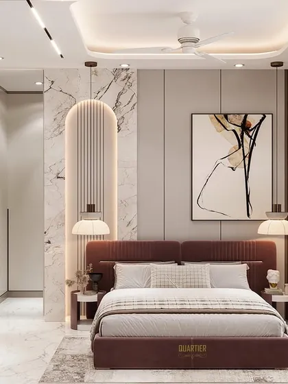 This master bedroom design for Gaur Saundaryam features a wall with sleek vertical grooves and an arch-shaped panel. The TV unit is integrated with a workstation, providing a functional and stylish solution.