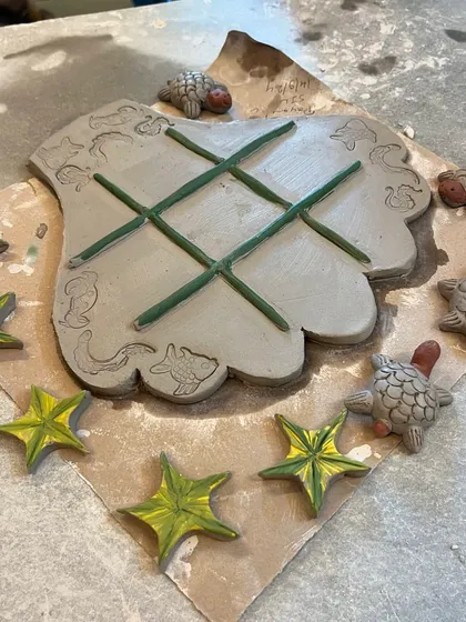 Another imaginative creation from our tic-tac-toe workshop. This set features a hand-shaped board with adorable turtles and starfish as the playing pieces.