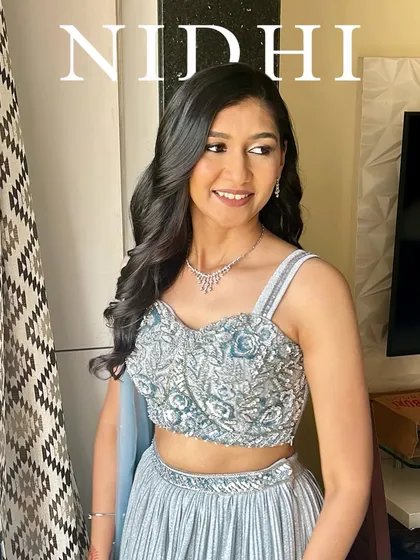 A simple and elegant engagement look. The makeup is clean and minimal, with soft waves in her hair, perfect for a modern and chic bride.