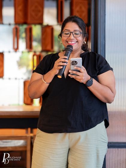 The warmth of a shared story is reflected in this performer's smile. Our open mics are as much about listening and connecting as they are about performing.